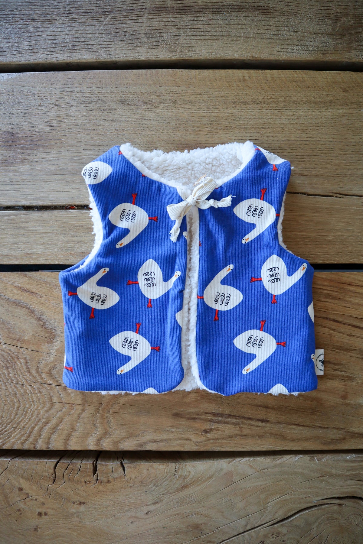 Gilet de berger bébé & enfant réversible – Motifs oies sur fond bleu
