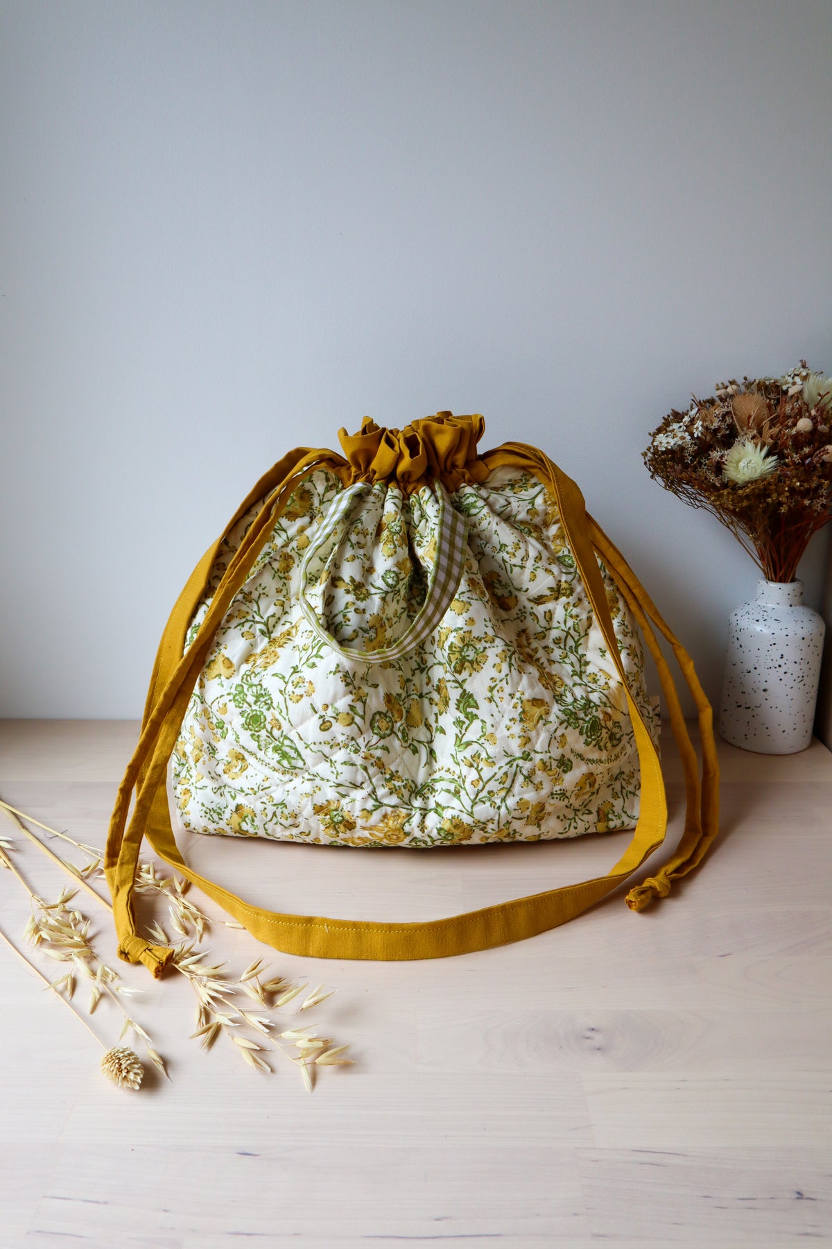Grand sac bourse à fleurs jaunes et vertes, fermé par cordons, avec bandoulière moutarde
